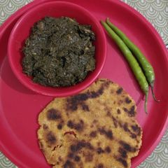 A picture of Sarso ka saag with makki ki roti.