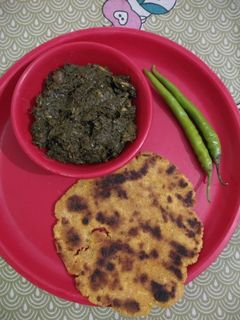 A picture of Sarso ka saag with makki ki roti.