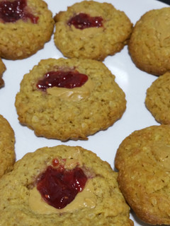 Una foto de Cookies de avena con aroma de limón, mermelada de frambuesa y crema de cacahuete