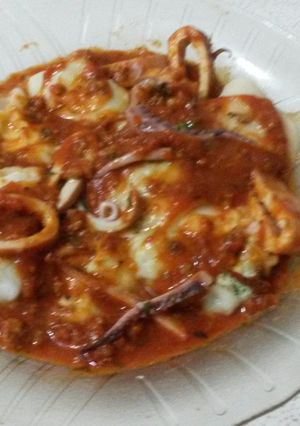 Una foto de Agñelottis de pollo y espinaca en salsa de calamares.