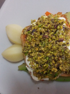 Una foto de Salmón costrado con queso fresco y pistachos