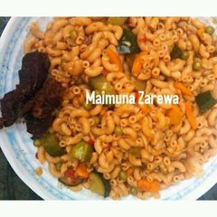 A picture of Macaroni vegetable jollof with grill beef.