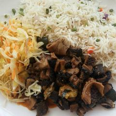 A picture of Wet-fried matumbo with rice and cabbages.