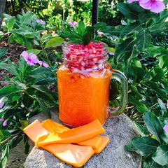 A picture of Papaya smoothie with pomegranate.