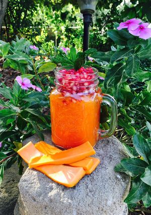 A picture of Papaya smoothie with pomegranate.