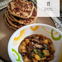 A picture of Naan bread with potatoes sauce.