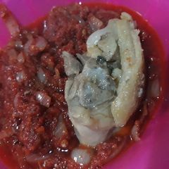 A picture of Tomato stew with chicken.