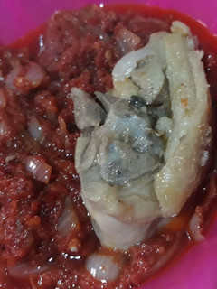 A picture of Tomato stew with chicken.