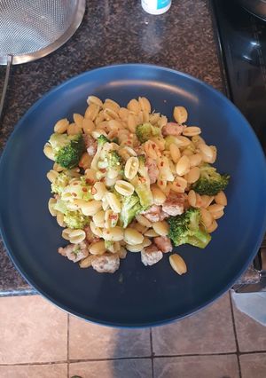 A picture of Pasta with broccoli and sausage.