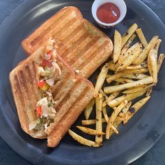 A picture of Boiled egg sandwich with French fries.