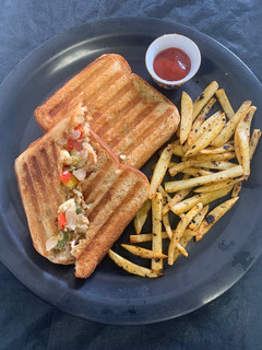 A picture of Boiled egg sandwich with French fries.