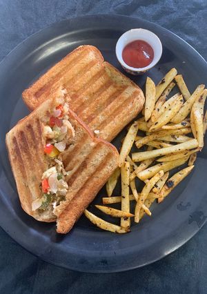 A picture of Boiled egg sandwich with French fries.