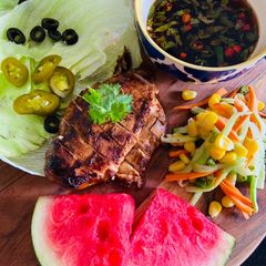 A picture of Spicy Chicken Breast with Asian Salad and Nuoc Cham wrapped in Lettuce Sheets.