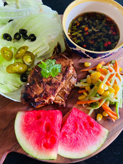 A picture of Spicy Chicken Breast with Asian Salad and Nuoc Cham wrapped in Lettuce Sheets.