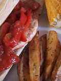 Spicy Cajun chicken with potato wedges and buttered corn