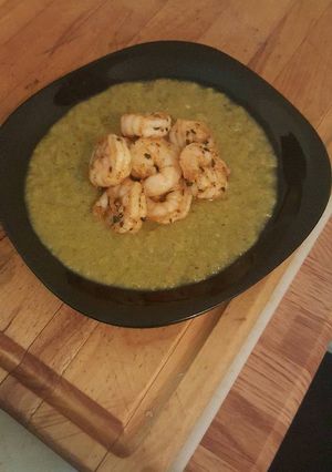 A picture of Pureed zucchini and summer squash with grilled shrimps.