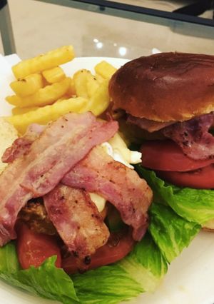 A picture of Pork and Chorizo burger with Brie and Bacon.