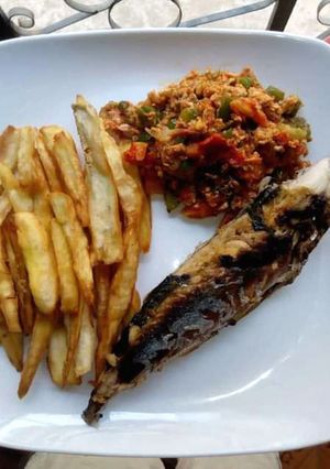 A picture of Potato chips,grilled fish and egg sauce.