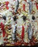 Pizza al orégano con sardinas y pimientos asados