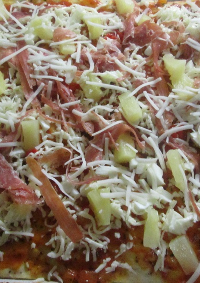 Una foto de Pizza con tiritas de jamón serrano y trocitos de piña