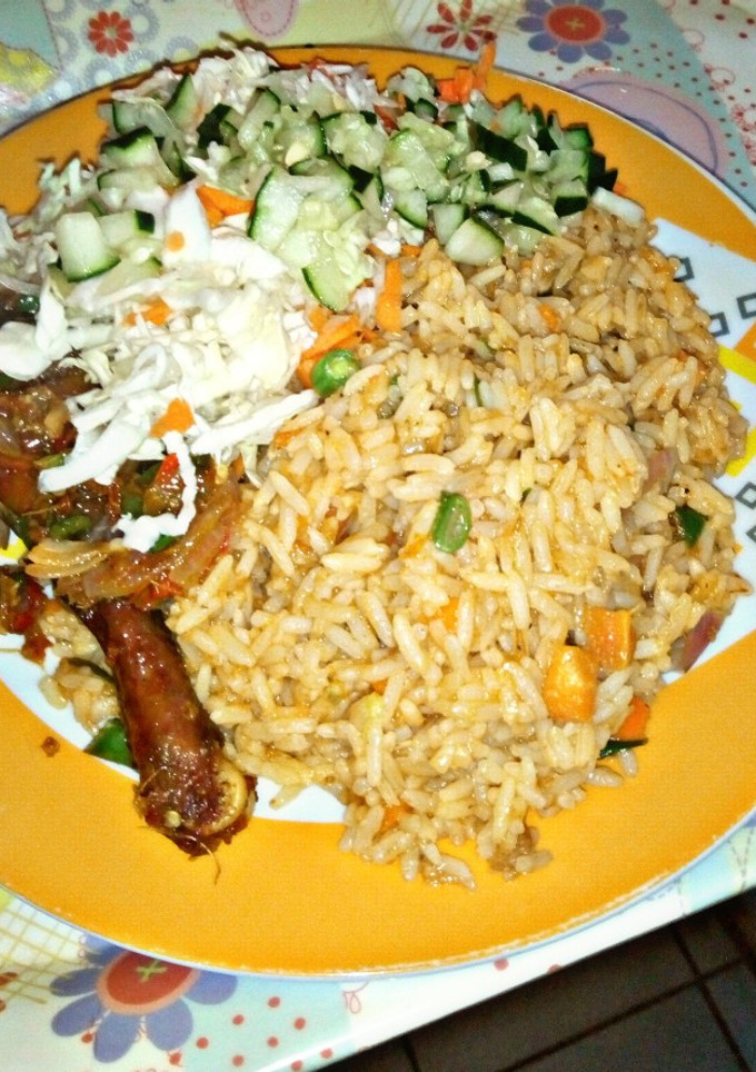A picture of Jollof Rice garnished with cucumber and cabbage.