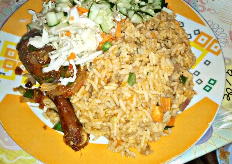 Jollof Rice garnished with cucumber and cabbage