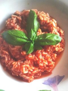 Una foto de Arroz al tomate y albahaca fresca 