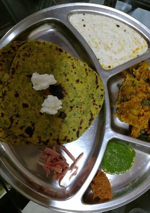 A picture of Makai ki roti with twist, aloo Gobhi sabzi, kheere ka raita.