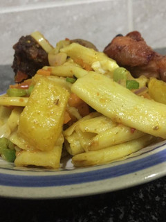 A picture of Homade Macaroni with Irish jollof & peppered chicken.