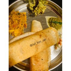 A picture of Masala Dosa with coconut & raw tomato chutney.
