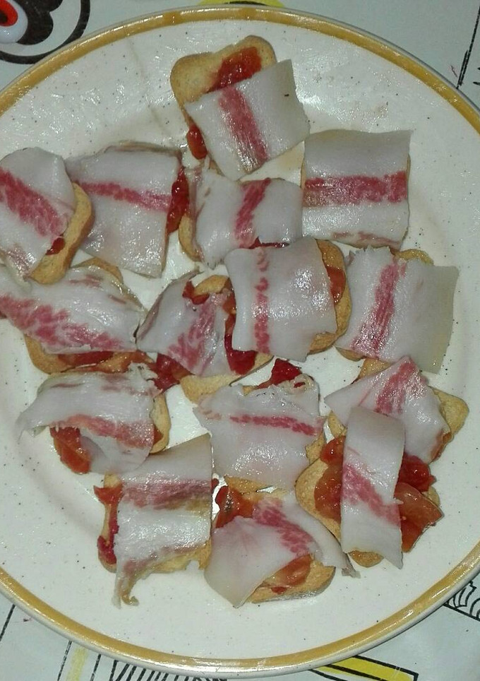 Una foto de Papada ibérica sobre panecillos con tomate 