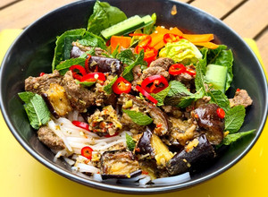 A picture of Vietnamese noodle bowl: Bun Bo Xao with lemongrass beef & 🍆.