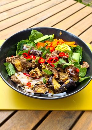 A picture of Vietnamese noodle bowl: Bun Bo Xao with lemongrass beef & 🍆.