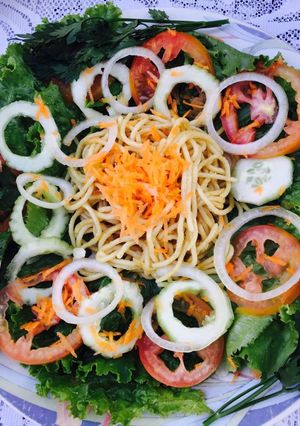 A picture of Low fat pasta on green salad.