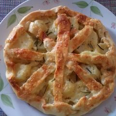 A picture of Rustic potato, rosemary and Parmesan pie.