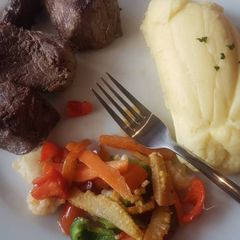 A picture of Mashed potato, stir fried veggies and fried beef.