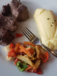 A picture of Mashed potato, stir fried veggies and fried beef.