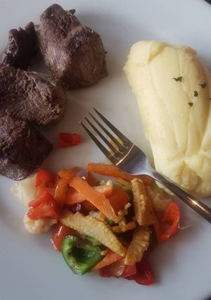 A picture of Mashed potato, stir fried veggies and fried beef.