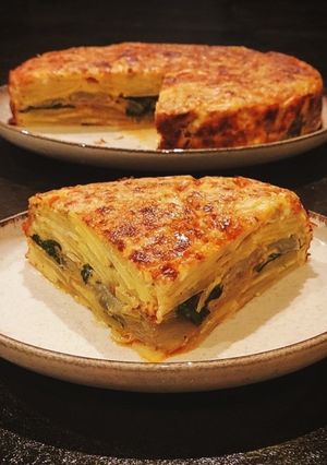 A picture of Swiss Chard and Potato Casserole with Crispy Pepper Powder, Feta, and Lemon Zest.