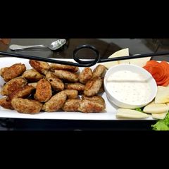 A picture of Kebabs with onion salad and spicy cream cheese sauce.