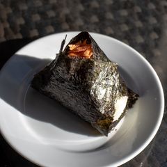 A picture of Onigiri with salmon flakes.