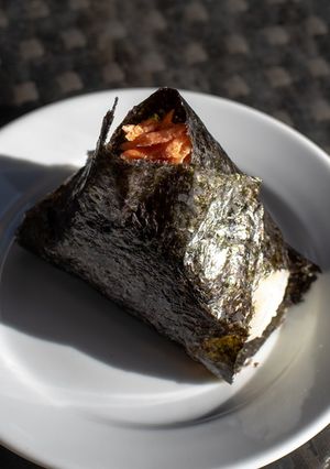 A picture of Onigiri with salmon flakes.