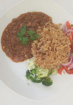 A picture of Pilau, served with minced meat and Kachumbari.