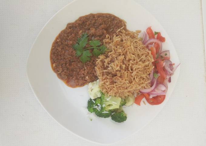 Pilau, served with minced meat and Kachumbari
