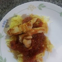A picture of Spaghetti squash with roasted tomato sauce and chicken.