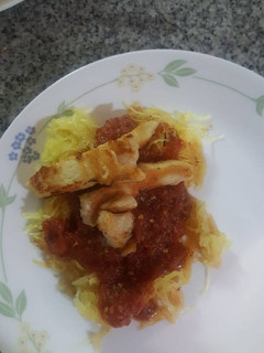 A picture of Spaghetti squash with roasted tomato sauce and chicken.