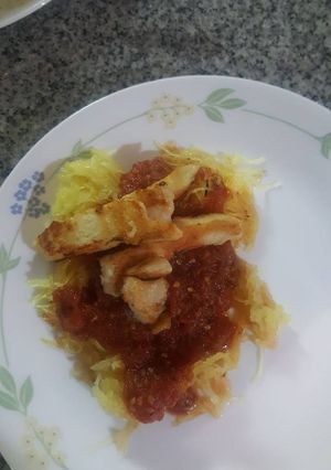 A picture of Spaghetti squash with roasted tomato sauce and chicken.
