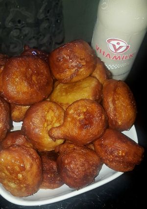 A picture of Puff puff with orange syrup.