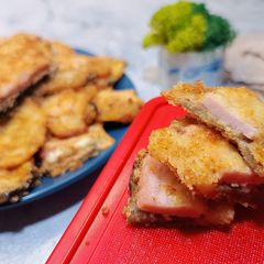 A picture of Oven-baked eggplant sandwiches with ham and cheese.