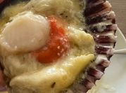 Una foto de ostiones a la parmesana